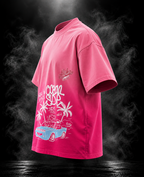 Aloha Ombre Love Boxy Fit Unisex T-Shirt by DUSTOFGODS, angled view showing pink textured body and large white beach car illustration.