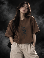Celestial boxy fit unisex brown T-shirt styled on a model with celestial moon and globe graphic