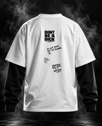 DUST OF GODS Don't Be A D#ck white and black oversized doctor sleeve unisex T-shirt front with winged emblem