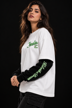 Kid with a Dream Oversized Doctor Sleeve Unisex T-Shirt by DUSTOFGODS, white oversized tee styled on a model with green airplane chest graphic and black sleeves.